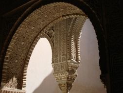 stone carving on ceiling in archway of alhambra palace, spain, granada