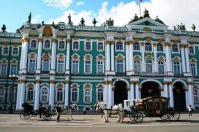 horse-drawn carriages on square at winter palace, russia, st petersburg