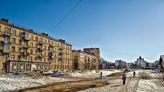 people walking on street at five-storey houses at winter, russia, saint petersburg