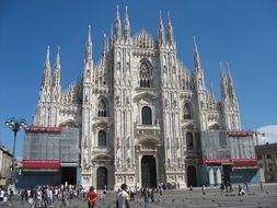 people on square at gothic cathedral, italy, milan