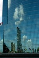 reflection of city on glass facade