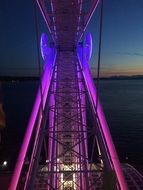 colorful illuminated ferris wheel construction at night