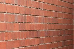 rows of red bricks, perspective of wall