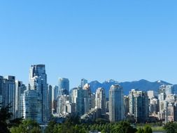 skyscrapers of modern city at mountains, canada, british columbia, vancouver