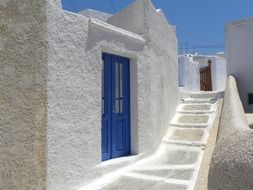 White houses with blue doors in Santorini