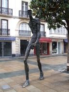 walking man, sculpture on sidewalk, spain, vitoria