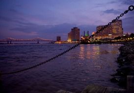 city on coast of mississippi river at dusk, usa, louisiana, new orleans