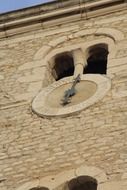 medieval stone wall with clock