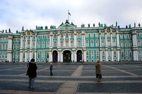 people on square at winter palace, russia, st petersburg