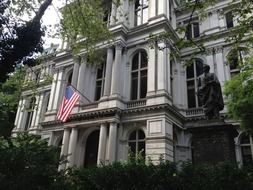 american flas on facade of old city hall, usa, massachusetts, boston