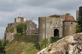 medieval dover castle on cliff at cloudy sky, uk, england