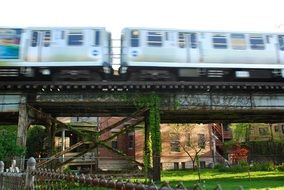 train speeding on railway bridge above buildings, usa, illinois, chicago