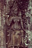 stone carved female figure on wall of ancient khmer temple, cambodia, angkor thom