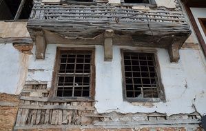 ruined facade of old house with broken windows