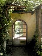 villa real, old arched door to garden, italy, tuscany