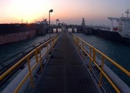 walkway of oil terminal at sunrise, iraq, al basra