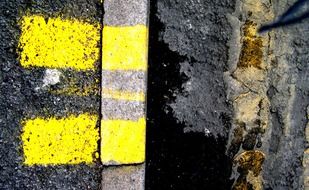 yellow markings on grey asphalt road