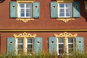 house windows with carved shutters