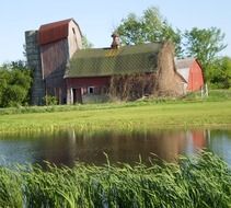 barn at pond in countryside