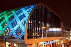 colorful illuminated facade of train station, poland, poznan