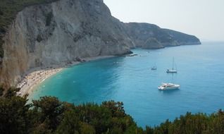 top view of beach on rocky coast at bay, greece, lefkada