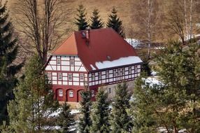 Local museum, truss building in forest at winter, switzerland