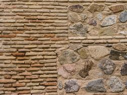 weathered bricks and wild stone, old wall