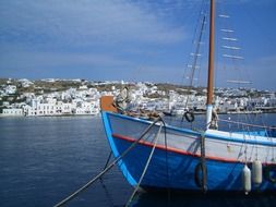 sailing boat anchored in view of coastal town, greece, mykonos