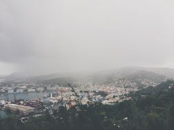 mist above city on coast at mountains