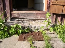old door mat at entrance to farm building
