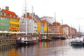 sailing boats on water at colourful houses, denmark, copenhagen, nyhavn