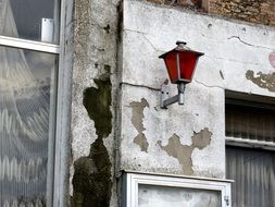 vintage red lantern on old ruined wall