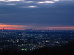 aerial view of night city under clouds, japan, tokyo