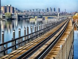 railroad on water under bridge at city, usa, new york city