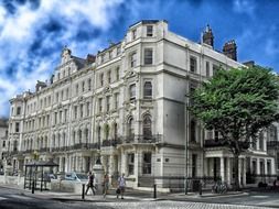 old corner building with porch on street, uk, england, brighton