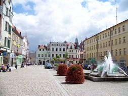 modern fountain on square in old town, poland, zary