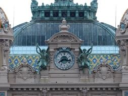 vintage clock with winged figures atop of casino facade, monaco, monte carlo