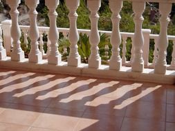 shadow of balustrade on tile floor