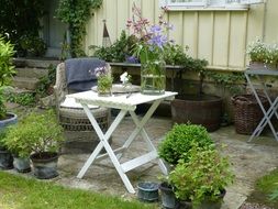 flowers on table and chair in garden