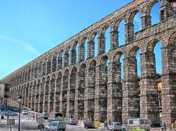 transport on road at ancient roman aquaduct, spain, segovia