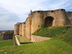 wall of medieval fortress on hill in countryside, france