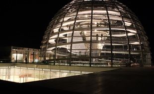 illuminated reichstag glass dome at night, germany, berlin