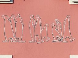 cartoon human silhouettes on pink facade wall