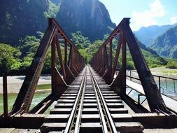 perspective of old railway bridge across river at mountains, usa, alabama, auburn