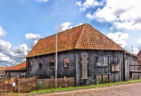 weathered wooden building of shop in countryside, netherlands