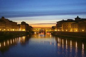 distant view of ponte vecchio at dusk in Italy, florence