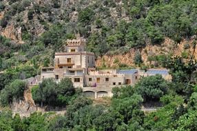 modern castle style building on mountain side, spain, tossa del mar