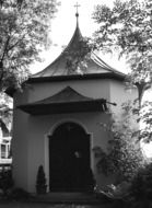 monochrome picture of small old chapel among trees