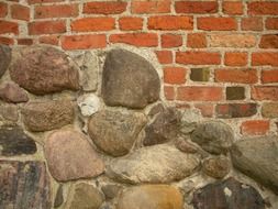 wild stone and red brick wall of medieval castle, detail