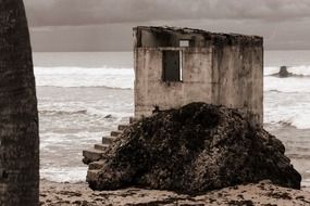 ruined cabin at stormy sea